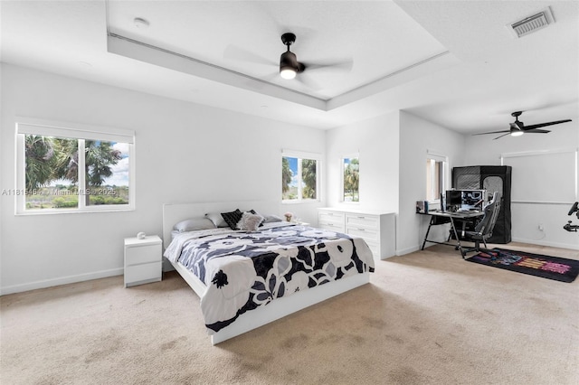 22618 SW 94th Path, Cutler Bay, FL 33190 - carpeted bedroom featuring a raised ceiling, multiple windows, baseboards, and ceiling fan
