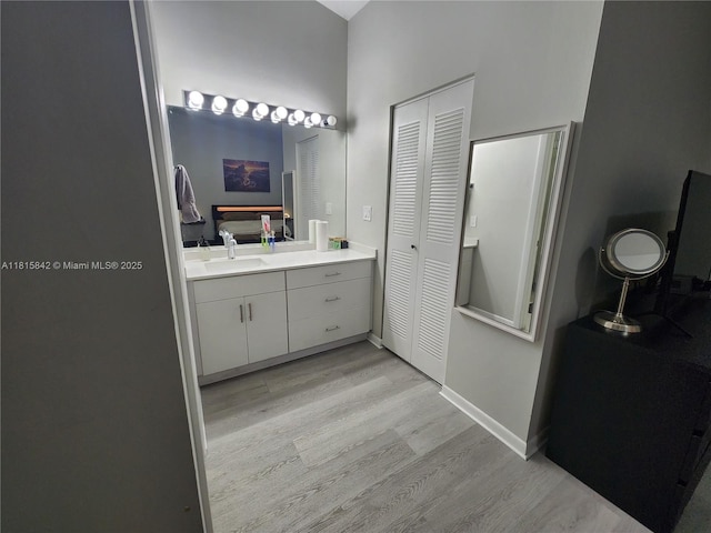 10875 NW 8th St, Pembroke Pines, FL 33026 - bathroom featuring a closet, wood finished floors, vanity, and baseboards