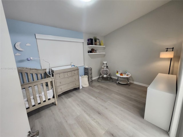 10875 NW 8th St, Pembroke Pines, FL 33026 - bedroom featuring wood finished floors, baseboards, and a crib