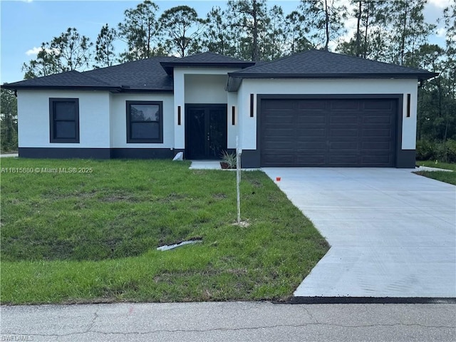 2607 E 13th St, Lehigh Acres, FL 33972 - prairie-style house featuring stucco siding, a garage, driveway, a front yard, and roof with shingles