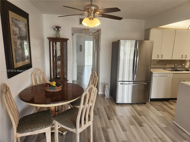 4144 Cambridge G 4144, Deerfield Beach, FL 33442 - dining area featuring light wood finished floors, a ceiling fan, and a textured ceiling
