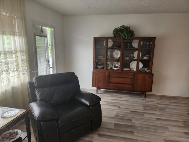 4144 Cambridge G 4144, Deerfield Beach, FL 33442 - sitting room with wood finished floors, a textured ceiling, and baseboards
