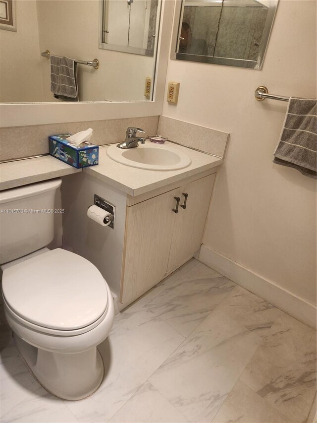 4144 Cambridge G 4144, Deerfield Beach, FL 33442 - half bath featuring marble finish flooring, vanity, toilet, and baseboards