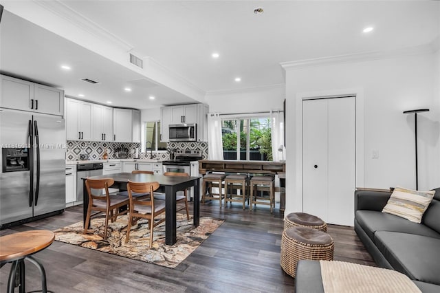 3145 Day Ave Unit 1, Miami, FL 33133 - dining space with crown molding, dark wood-type flooring, and recessed lighting