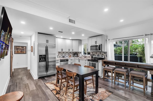 3145 Day Ave Unit 1, Miami, FL 33133 - dining space with crown molding, wood finished floors, recessed lighting, and baseboards