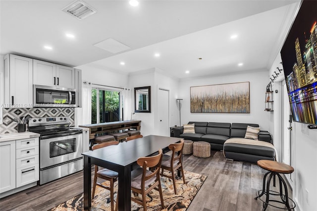 3145 Day Ave Unit 1, Miami, FL 33133 - kitchen with stainless steel appliances, dark wood-type flooring, recessed lighting, crown molding, and backsplash