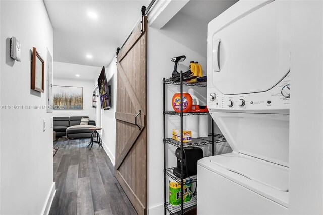 3145 Day Ave Unit 1, Miami, FL 33133 - laundry room with a barn door, stacked washer / dryer, wood finished floors, recessed lighting, and baseboards