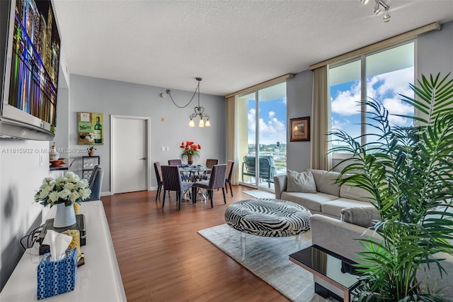 2775 NE 187th St Unit Ph6, Aventura, FL 33180 - living room with a chandelier, a textured ceiling, wood finished floors, and floor to ceiling windows
