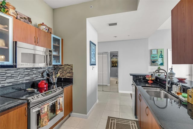 2775 NE 187th St Unit Ph6, Aventura, FL 33180 - kitchen featuring appliances with stainless steel finishes, a sink, tasteful backsplash, dark stone countertops, and baseboards