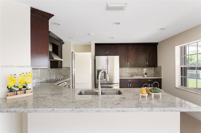 210 Somerset Way, Weston, FL 33326 - kitchen featuring stainless steel fridge with ice dispenser, a sink, dark brown cabinets, light stone counters, and decorative backsplash