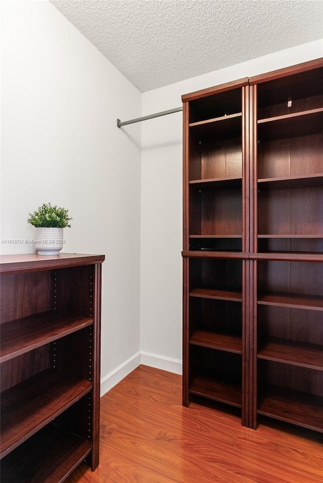 210 Somerset Way, Weston, FL 33326 - spacious closet featuring wood finished floors
