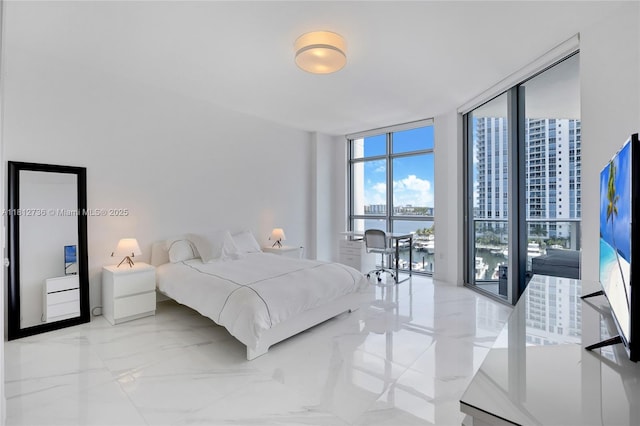 17301 Biscayne Blvd Unit 605, North Miami Beach, FL 33160 - bedroom with multiple windows, light marble finish floors, and a wall of windows