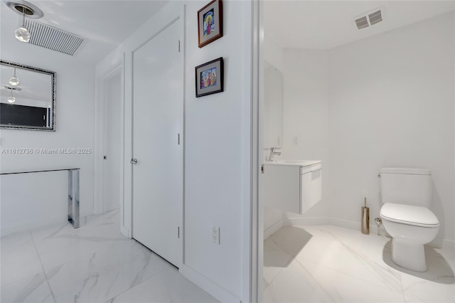 17301 Biscayne Blvd Unit 605, North Miami Beach, FL 33160 - bathroom featuring vanity, toilet, and marble finish floors