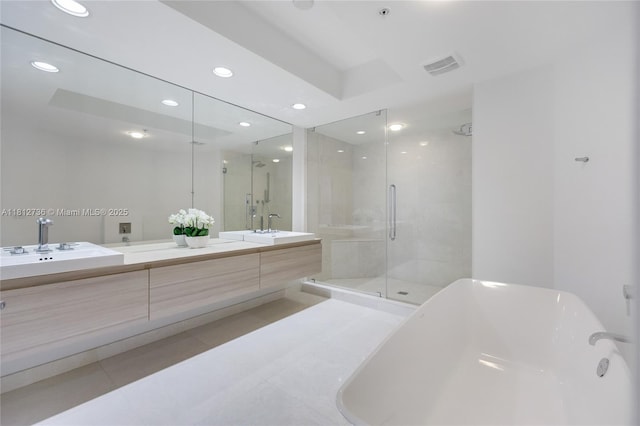 17301 Biscayne Blvd Unit 605, North Miami Beach, FL 33160 - full bathroom featuring tile patterned flooring, double vanity, a soaking tub, a shower stall, and recessed lighting