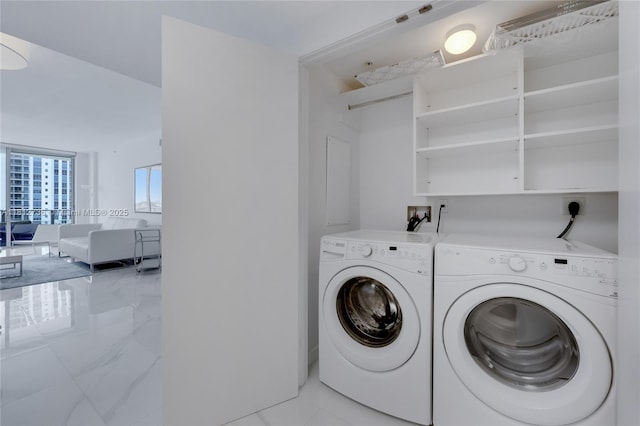 17301 Biscayne Blvd Unit 605, North Miami Beach, FL 33160 - laundry room with washing machine and clothes dryer and light tile patterned floors