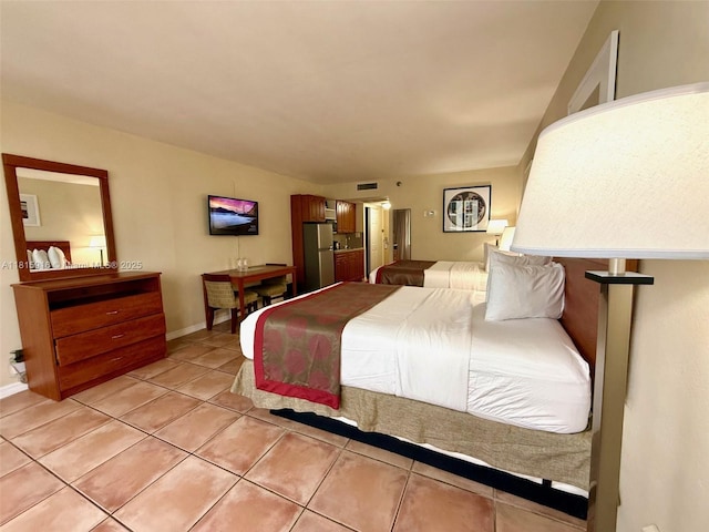 19201 Collins Ave Unit 1019, Sunny Isles Beach, FL 33160 - bedroom with freestanding refrigerator, light tile patterned floors, and baseboards