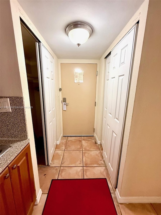 19201 Collins Ave Unit 1019, Sunny Isles Beach, FL 33160 - doorway with light tile patterned flooring and baseboards