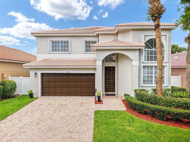 1981 NW 171st Ave, Pembroke Pines, FL 33028 - mediterranean / spanish-style home with decorative driveway, a garage, stucco siding, and a tile roof