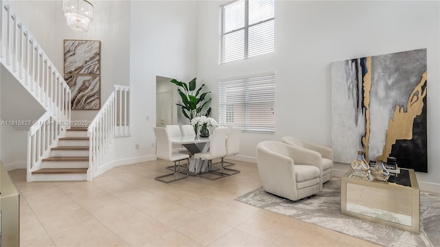 1981 NW 171st Ave, Pembroke Pines, FL 33028 - living area with stairs, a towering ceiling, baseboards, and tile patterned floors