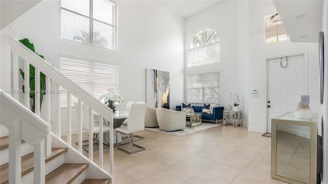 1981 NW 171st Ave, Pembroke Pines, FL 33028 - living room with a high ceiling, stairway, and light tile patterned flooring