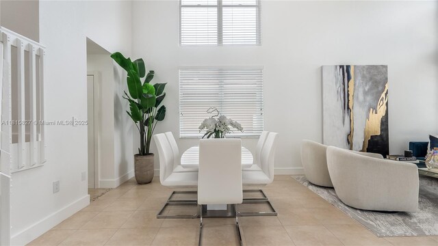 1981 NW 171st Ave, Pembroke Pines, FL 33028 - dining area featuring a towering ceiling, tile patterned floors, and baseboards