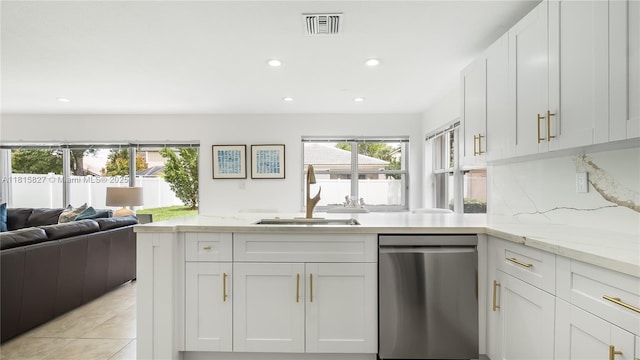 1981 NW 171st Ave, Pembroke Pines, FL 33028 - kitchen with stainless steel dishwasher, a sink, white cabinetry, open floor plan, and light stone counters