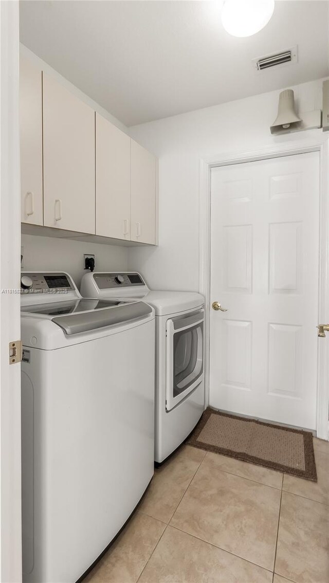 1981 NW 171st Ave, Pembroke Pines, FL 33028 - laundry area with washer and clothes dryer, cabinet space, and light tile patterned flooring