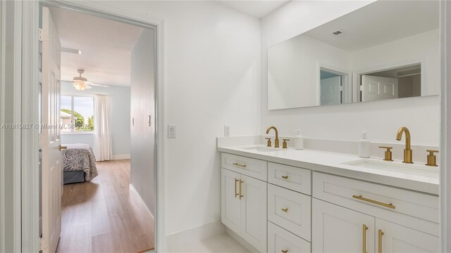 1981 NW 171st Ave, Pembroke Pines, FL 33028 - ensuite bathroom with double vanity, wood finished floors, ceiling fan, and baseboards