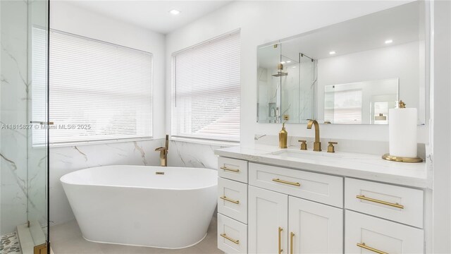 1981 NW 171st Ave, Pembroke Pines, FL 33028 - full bath with vanity, a marble finish shower, a soaking tub, tile walls, and wainscoting