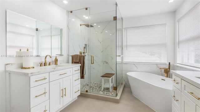 1981 NW 171st Ave, Pembroke Pines, FL 33028 - bathroom with a marble finish shower, vanity, a freestanding bath, tile walls, and recessed lighting