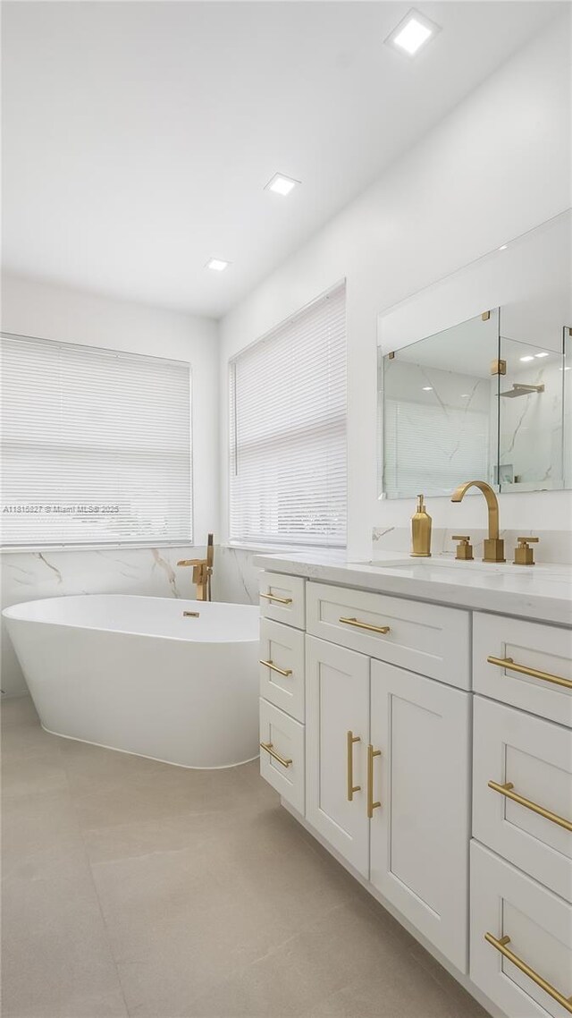 1981 NW 171st Ave, Pembroke Pines, FL 33028 - bathroom with vanity, a freestanding tub, a marble finish shower, and tile walls