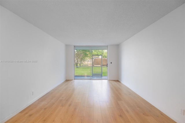 9601 Sunrise Lakes Blvd Unit 106, Sunrise, FL 33322 - empty room with light wood-style floors and expansive windows