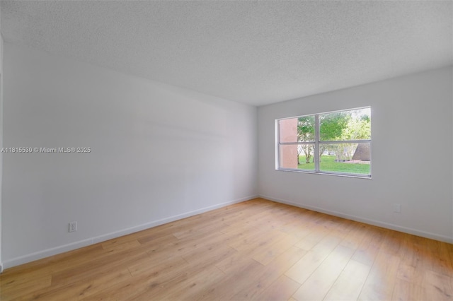 9601 Sunrise Lakes Blvd Unit 106, Sunrise, FL 33322 - empty room with light wood-type flooring, a textured ceiling, and baseboards