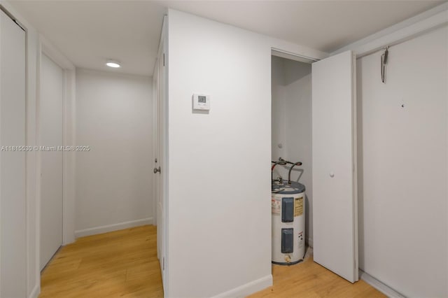 9601 Sunrise Lakes Blvd Unit 106, Sunrise, FL 33322 - corridor featuring electric water heater and light wood-type flooring