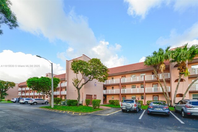 9601 Sunrise Lakes Blvd Unit 106, Sunrise, FL 33322 - view of apartment building / complex featuring uncovered parking