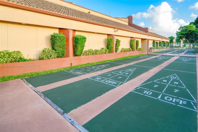 9601 Sunrise Lakes Blvd Unit 106, Sunrise, FL 33322 - view of community with shuffleboard and uncovered parking
