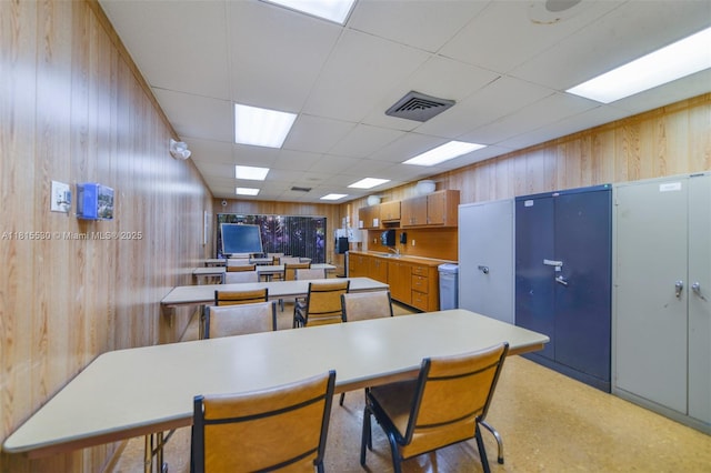 9601 Sunrise Lakes Blvd Unit 106, Sunrise, FL 33322 - kitchen with wood walls, a drop ceiling, and light countertops