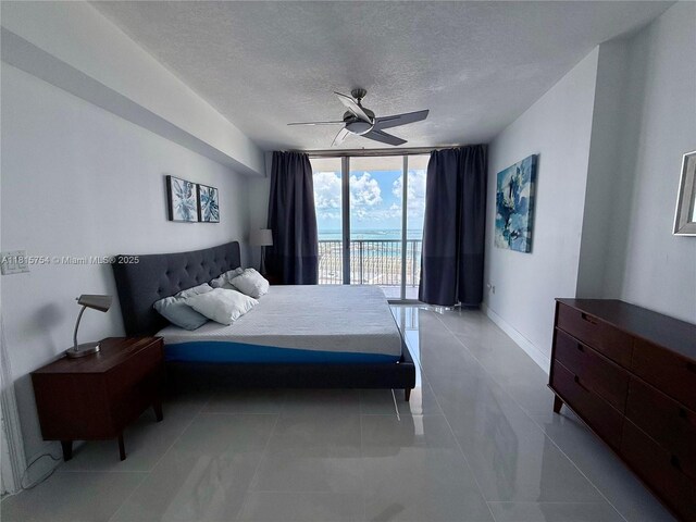 1750 N Bayshore Dr Unit 4604, Miami, FL 33132 - tiled bedroom with access to outside, a wall of windows, a textured ceiling, and ceiling fan