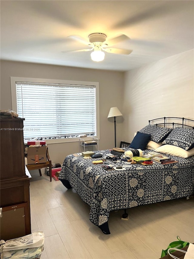 10830 SW 72nd St Unit 14, Miami, FL 33173 - bedroom with multiple windows, a ceiling fan, and light wood-type flooring