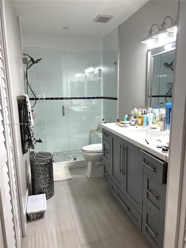 10830 SW 72nd St Unit 14, Miami, FL 33173 - full bathroom featuring toilet, vanity, a stall shower, and wood finished floors