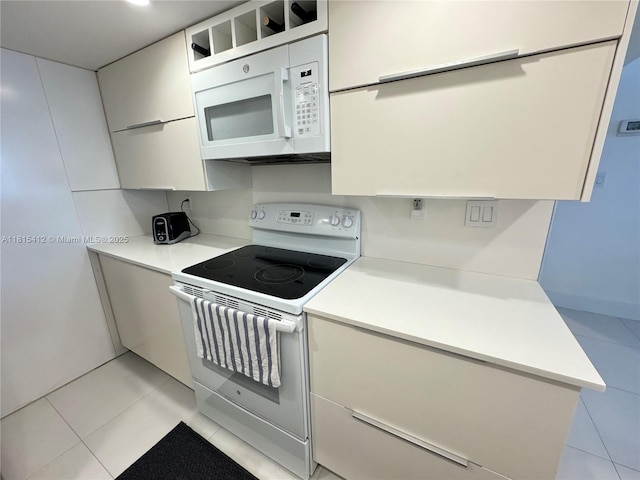100 Lincoln Rd Unit 1035, Miami Beach, FL 33139 - kitchen featuring white appliances, light countertops, light tile patterned flooring, and modern cabinets