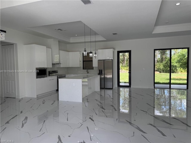 1016 Magnolia Ave, Lehigh Acres, FL 33974 - kitchen featuring stainless steel appliances, a raised ceiling, modern cabinets, white cabinetry, and a center island