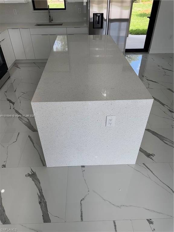 1016 Magnolia Ave, Lehigh Acres, FL 33974 - detailed view of a sink and stainless steel fridge with ice dispenser