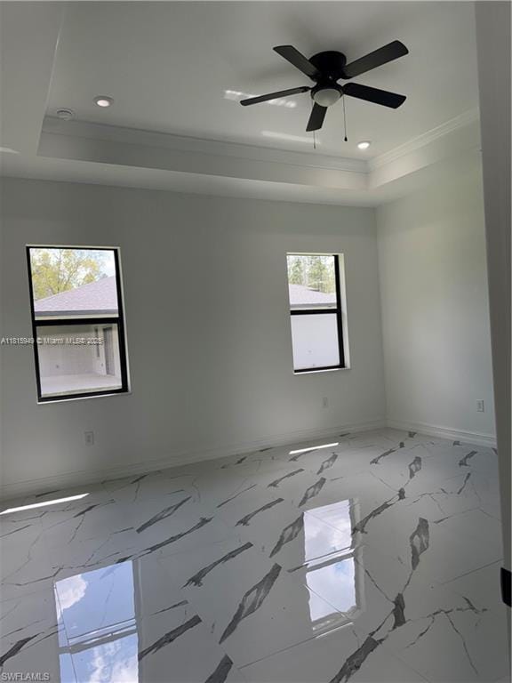 1016 Magnolia Ave, Lehigh Acres, FL 33974 - empty room with a tray ceiling, baseboards, recessed lighting, ornamental molding, and a ceiling fan