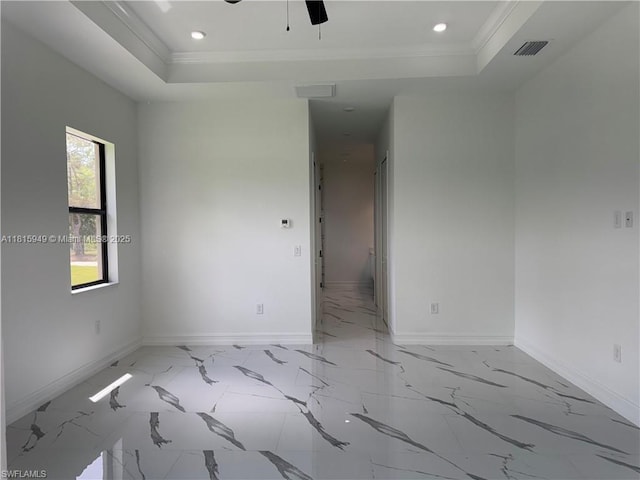 1016 Magnolia Ave, Lehigh Acres, FL 33974 - spare room featuring a raised ceiling, baseboards, light marble finish floors, crown molding, and recessed lighting