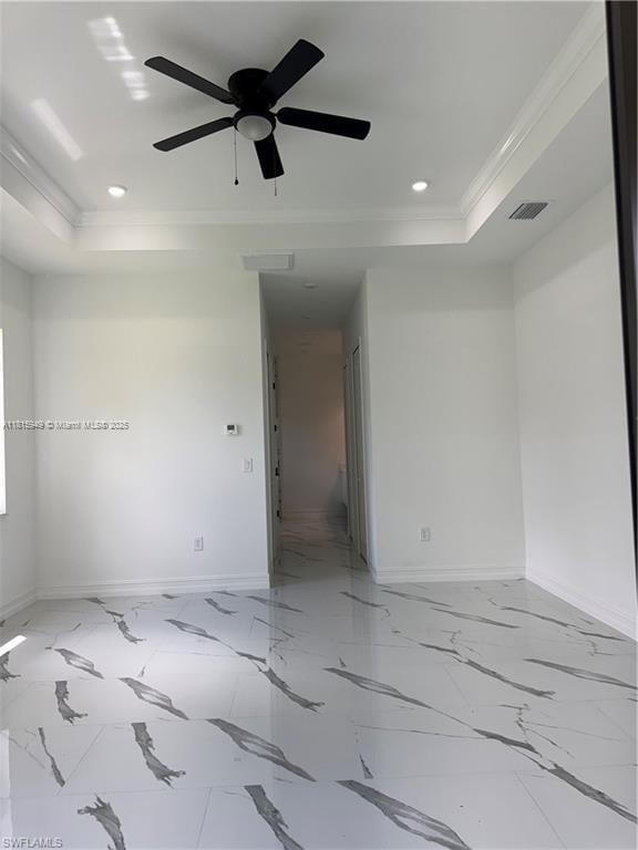 1016 Magnolia Ave, Lehigh Acres, FL 33974 - unfurnished room with ornamental molding, a tray ceiling, baseboards, recessed lighting, and marble finish floors