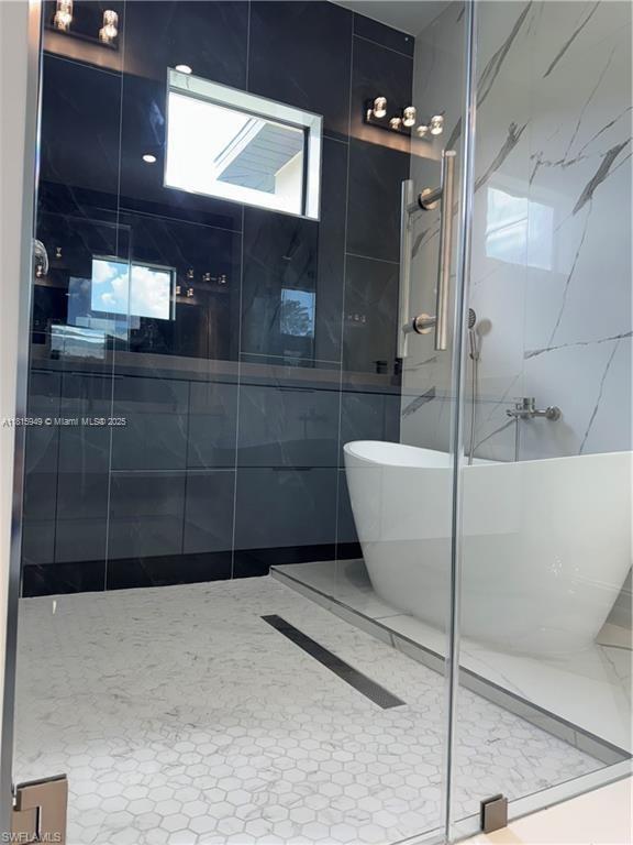 1016 Magnolia Ave, Lehigh Acres, FL 33974 - full bathroom featuring a stall shower and a soaking tub