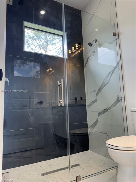 1016 Magnolia Ave, Lehigh Acres, FL 33974 - full bath featuring toilet, a marble finish shower, and marble finish flooring