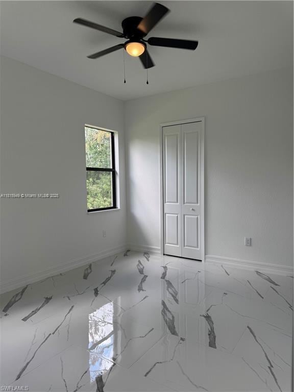 1016 Magnolia Ave, Lehigh Acres, FL 33974 - spare room featuring ceiling fan, baseboards, and marble finish floors