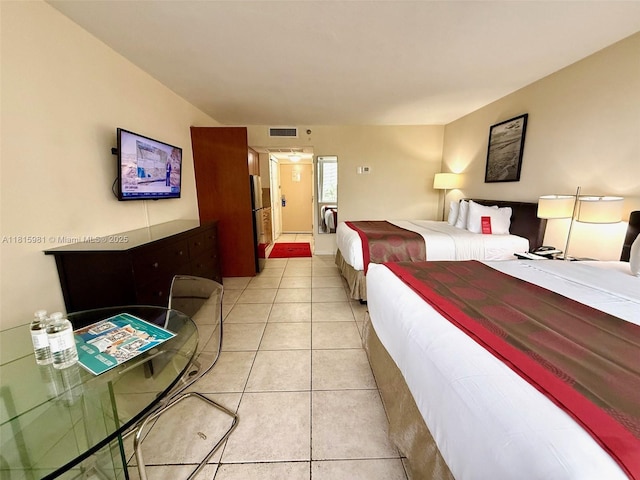 19201 Collins Ave Unit 242, Sunny Isles Beach, FL 33160 - bedroom with light tile patterned floors and freestanding refrigerator